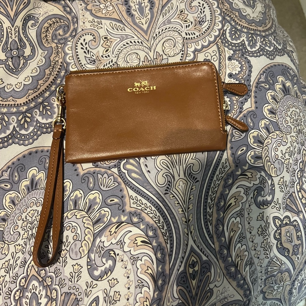 Double zipper brown coach wristlet wallet.